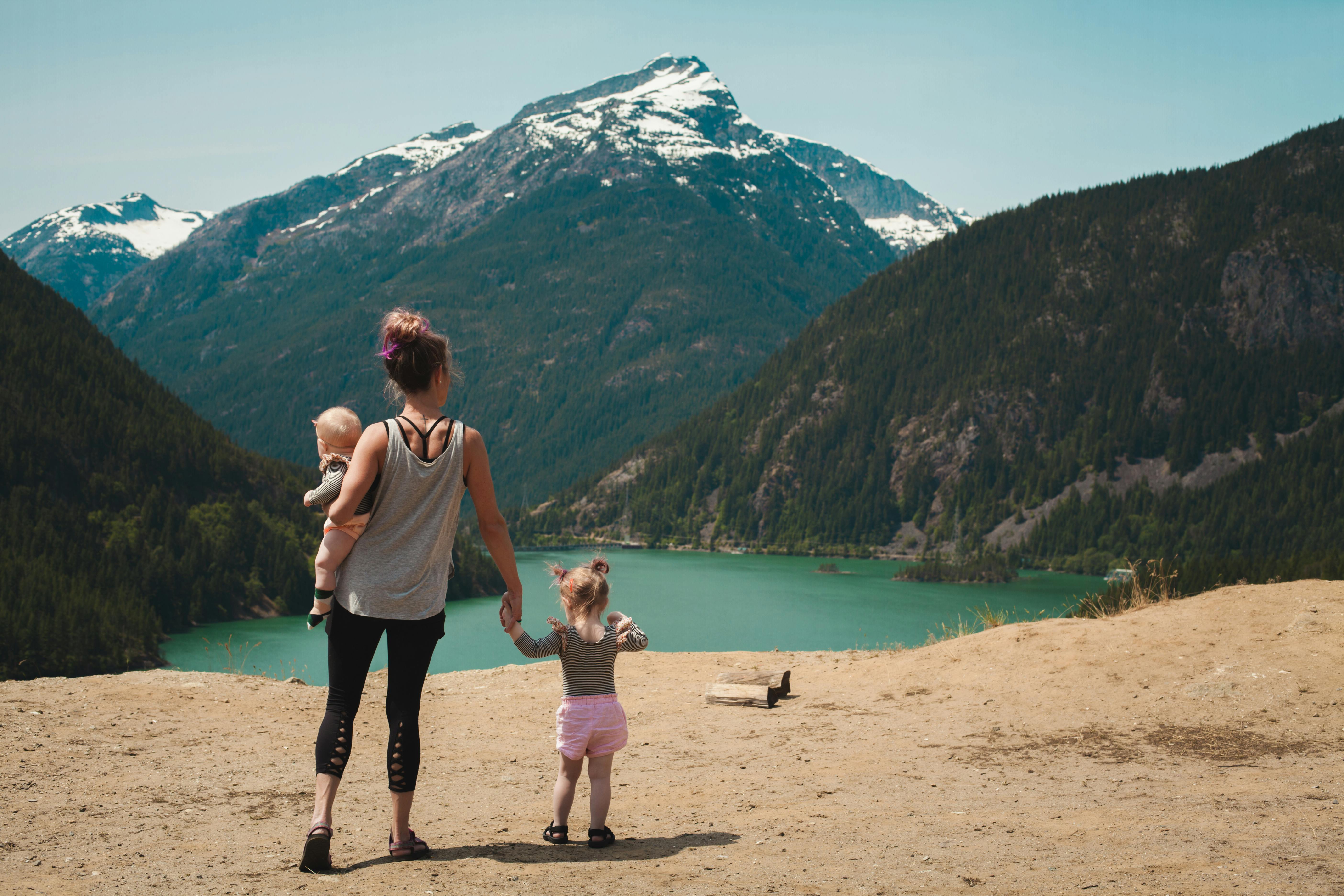 Mother with children looking toward mountain vista representing future vision